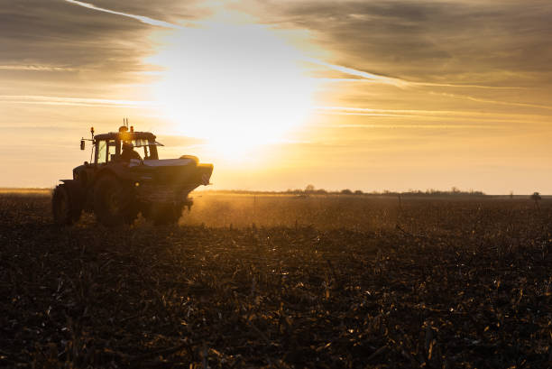 istock Tractor spreading artificial fertilizers in field 1389627620