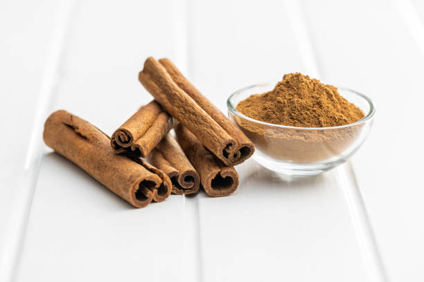 istock Dry cinnamon sticks and cinnamon powder on white table. 1389629587