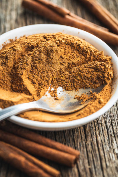 istock Dry cinnamon sticks and cinnamon powder on wooden table. 1389629677