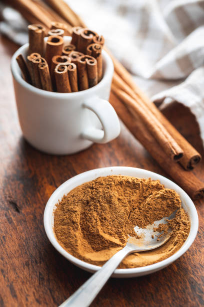 istock Dry cinnamon sticks and cinnamon powder on wooden table. 1389629724
