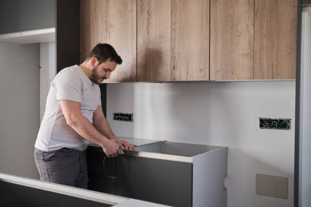 istock Young latin man using measuring tape before placing countertops on kitchen. 1389629870
