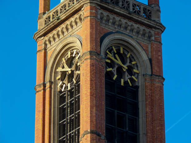 istock Church tower with clock and blue sky 1389631252