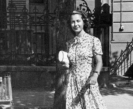 Beautiful Young Woman walking on a street. 1938.