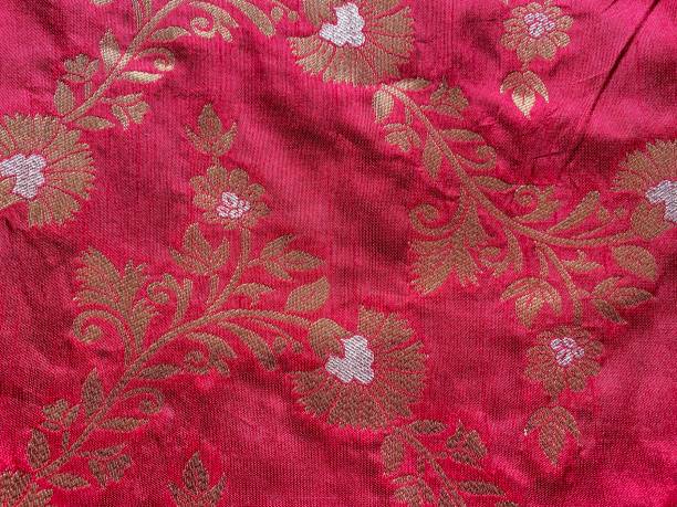 istock Beautiful Multi Color Leafy Embroidery Work On Red Tissue Fabric 1389632752