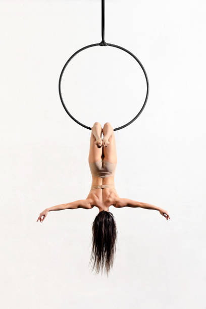 istock Unrecognizable aerialist performing bat trick on aerial hoop 1389632880