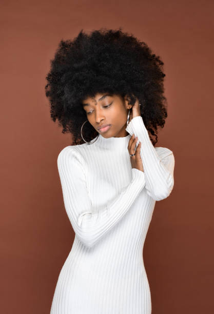 Stylish slim black woman in studio