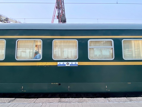 Langfang, Hebei, China- August 6, 2021: Although the high-speed railway system is very developed in China, there is still widely used- oridinary speed train line in more area in China. From Langfang, a small city around Beijing, there are several old style odinary trains heading to Beijing everyday. Here is train arriving Langfang North Station.