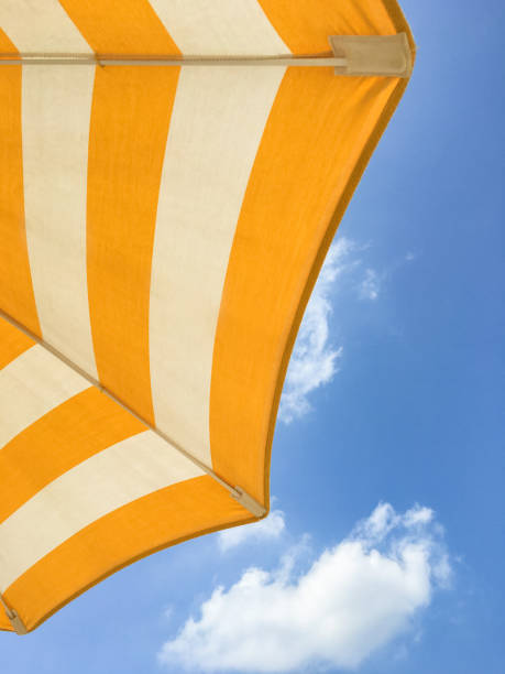 istock Yellow umbrella on the beach 1389637590