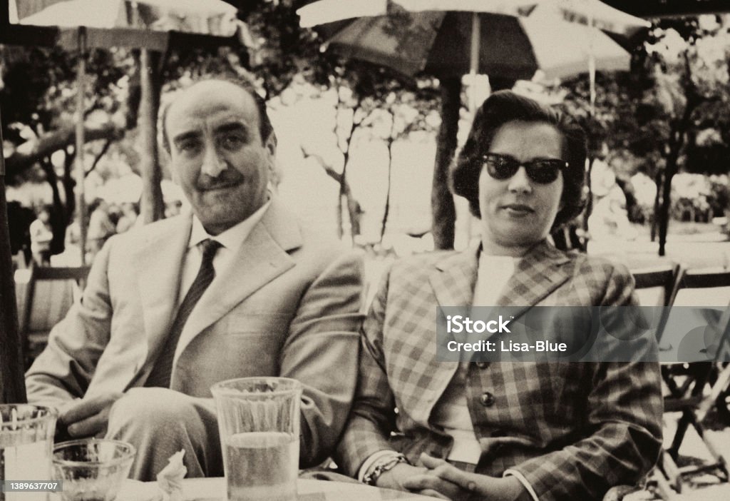 Happy couple at a sidewalk cafe in 1952. Couple at a sidewalk cafe in 1952. sepia toned. Retro Style Stock Photo