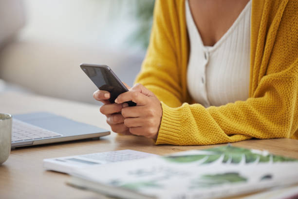 istock Shot of an unrecognizable businessperson using a phone at work 1389639156