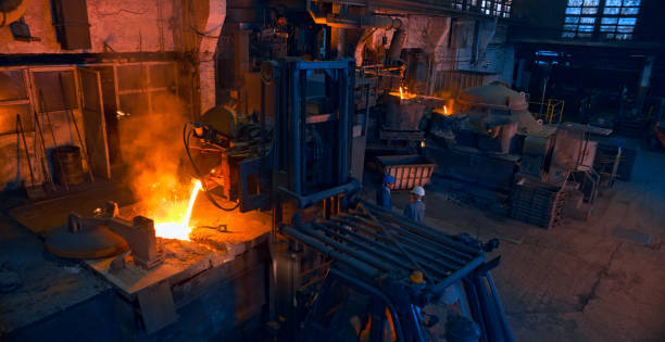 istock Engineers standing in steel mill. 1389640442