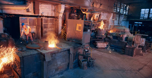 istock Man melting metal in foundry 1389640448