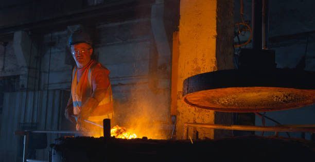 istock Man melting metal in foundry 1389640453