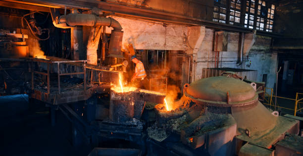 istock Man melting metal in foundry 1389640457