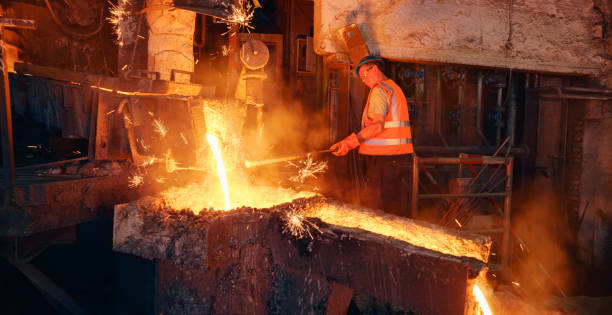 istock Man melting metal in foundry 1389640476