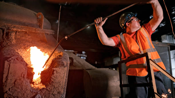 istock Man melting metal in foundry 1389640481