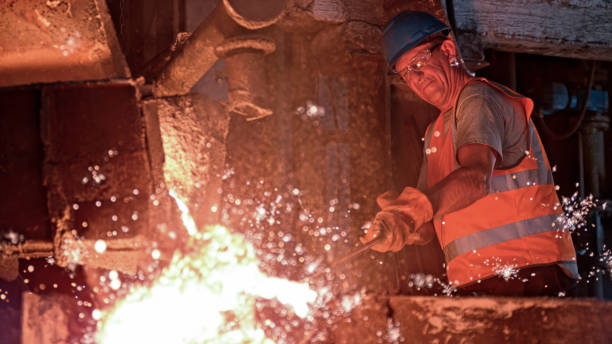 istock Man melting metal in foundry 1389640484
