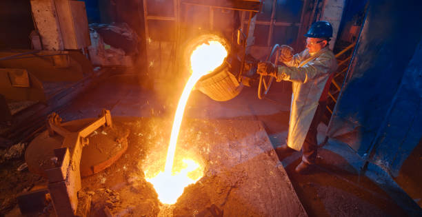 istock Worker pouring molten metal 1389640496