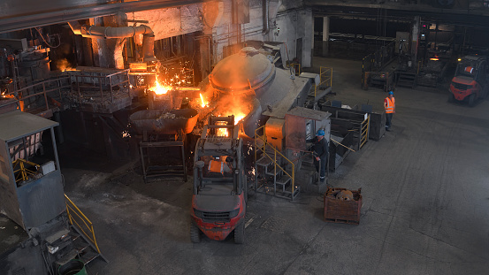 Elevated view of people working in steel mill.