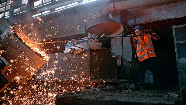 istock Man melting metal in foundry 1389640507