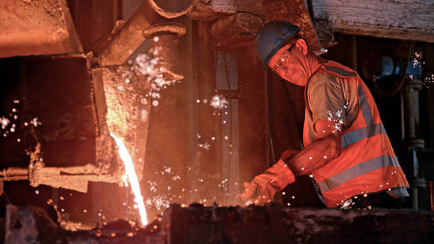 istock Man melting metal in foundry 1389640609