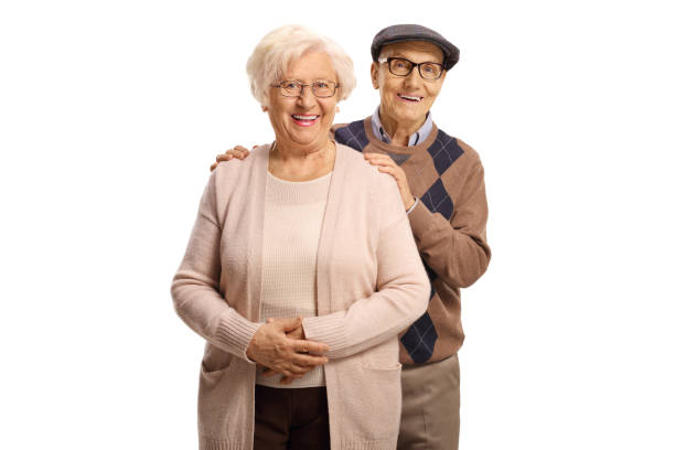 妻の後ろに立つ年配の夫 - couple indoors studio shot horizontal ストックフォトと画像