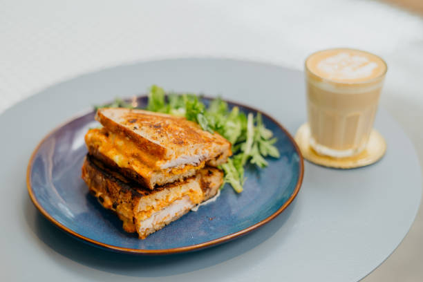 istock Freshly baked tuna sandwich and flat white coffee in cafe 1389641463