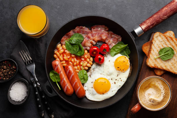 istock English breakfast with fried eggs, beans, bacon and sausages 1389642713