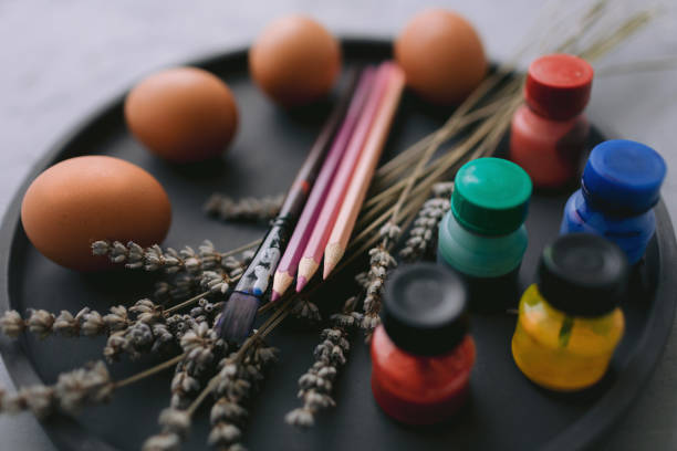 istock Multicolour paints and brushes on the plate with eggs. 1389643066