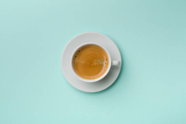 istock Cup of delicious coffee on color background, top view 1389643152