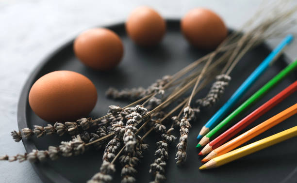 istock Multicolour paints and brushes on the plate with eggs. 1389643211