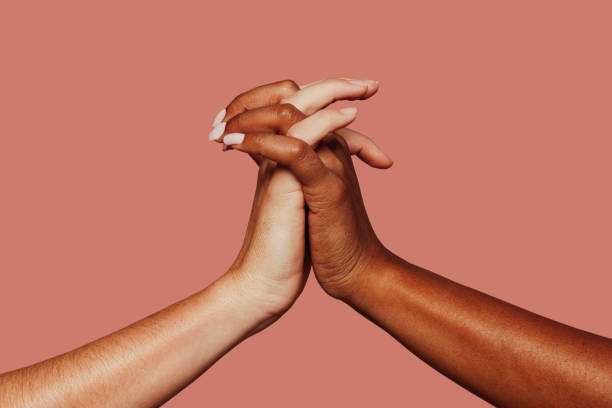 istock Close up multiracial black and white hands holding each other 1389643827