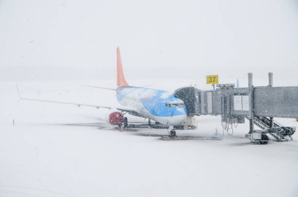 Airplane at the departure gate during snowing