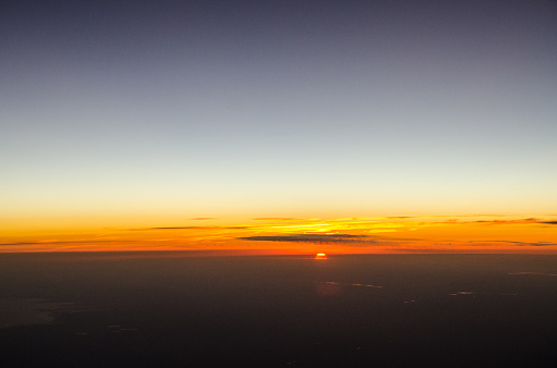 Sunset viewed from airplane porthole