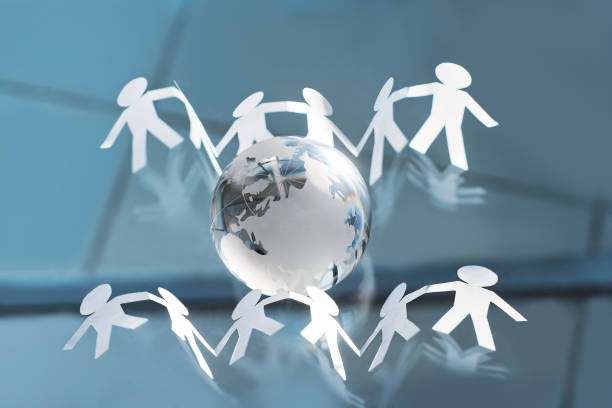 istock background image a group of paper men around a glass globe 1389644173
