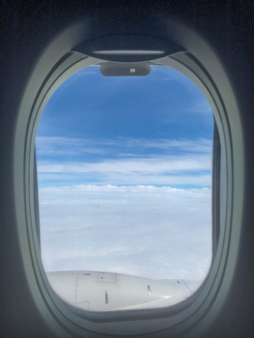 Sky and engine from airplane porthole