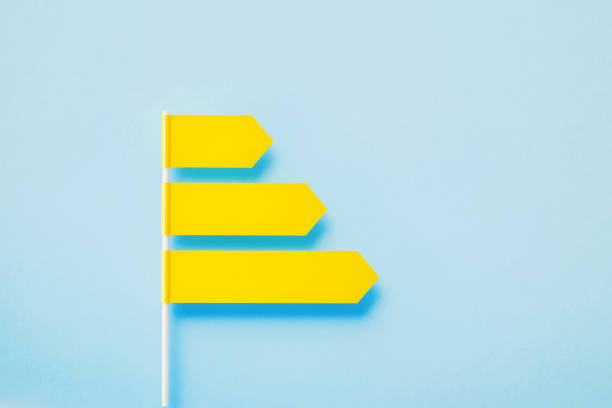 istock Three Yellow Directional Signs Over Blue Background 1389646827