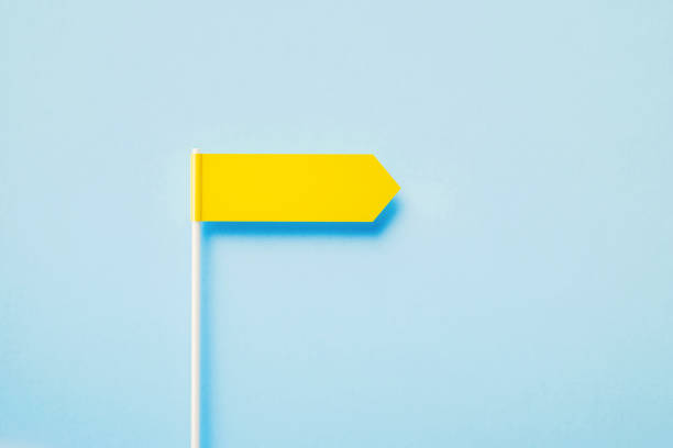 istock Yellow Directional Sign Over Blue Background 1389646888