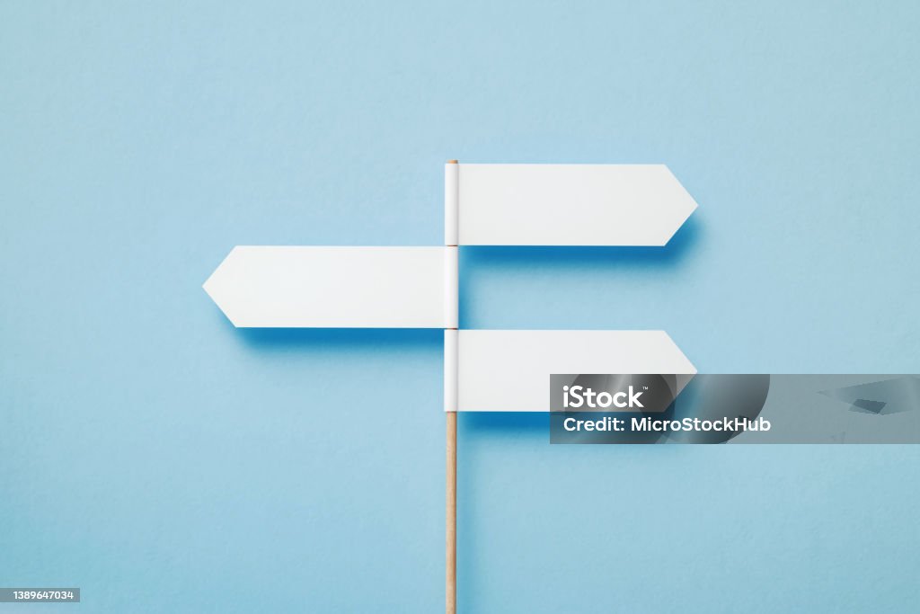 Three Directional Signs Pointing Opposite Directions Over Blue Background Three directional signs pointing opposite directions over blue background. Horizontal composition with copy space. Direction Stock Photo