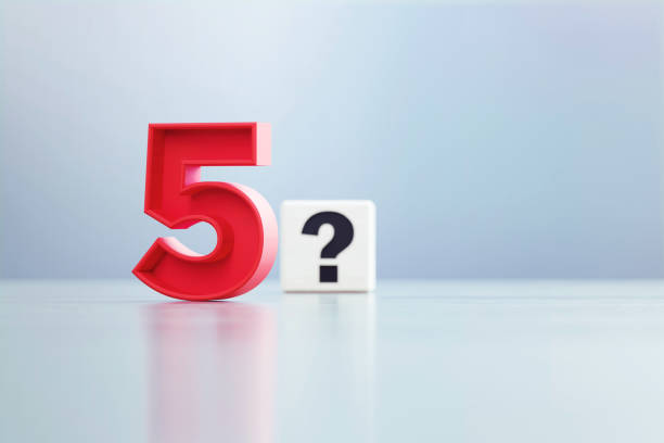 Red Number 5 And Question Mark Written White Cube Sitting Before Defocused  Background