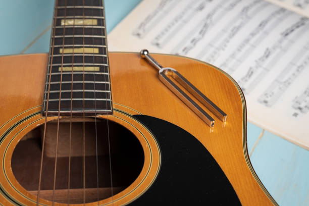 istock acoustic guitar tuning fork and music sheets 1389647380