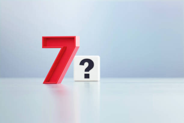 istock Red Number 7 And Question Mark Written White Cube Sitting Before Defocused  Background 1389647450