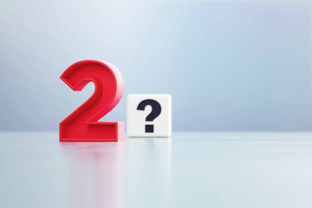 istock Red Number 2 And Question Mark Written White Cube Sitting Before Defocused  Background 1389648115