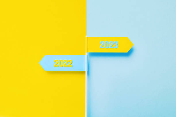istock 2022 And 2023 Written Directional Signs Pointing Opposite Directions Over Yellow And Blue Background 1389648564