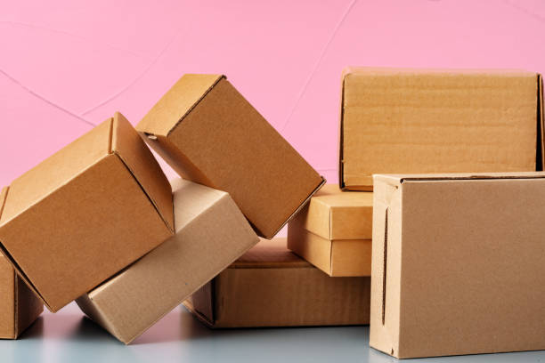 istock Set of cardboard boxes on pink background 1389649581