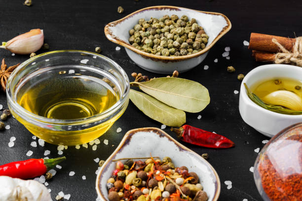 istock Olive oil, herbs and spices on black background 1389649694