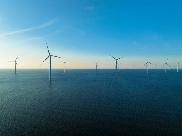 istock Wind turbines in an offshore wind park producing electricity 1389649733