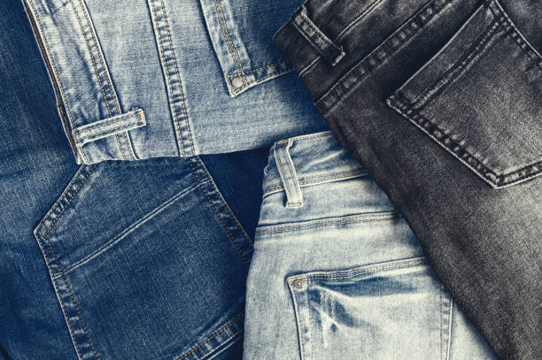 Variety of comfortable casual trousers, top view, copy space. Image with retro toning. Variety of comfortable casual trousers, top view, copy space. Image with retro toning. jeans stock pictures, royalty-free photos & images