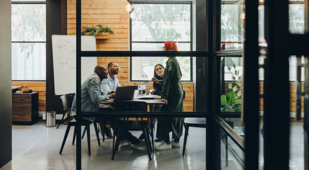 istock Multiethnic businesspeople having a meeting in a creative office 1389652633