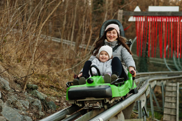 istock Mother with daughter ride electric sleigh on rails. 1389652978